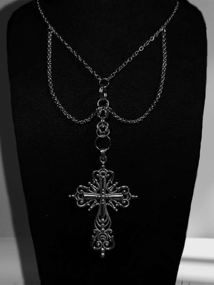 Handmade necklace with large dangling cross details and extra chains