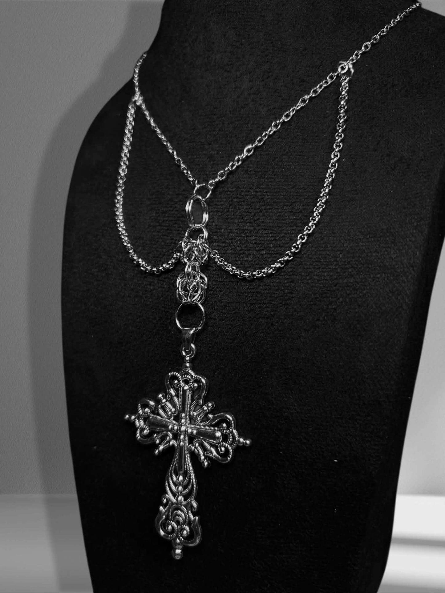 Handmade necklace with large dangling cross details and extra chains